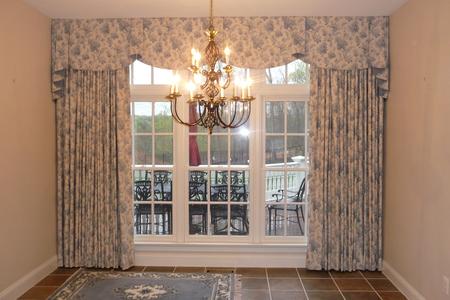Patterned drapes and a shaped valance